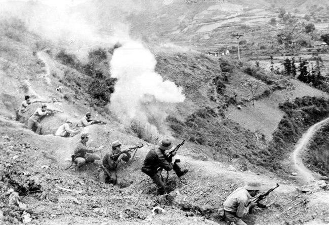 Vietnamese soldiers fighting on a smoke-covered hillside in 1979